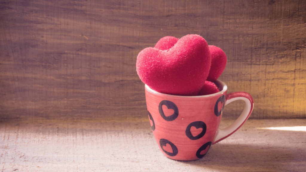 Cup filled with hearts to symbolize filling your own cup with your own love. Put yourself First
